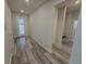 Bright entryway with gray, wood-look tile flooring and view of front door with sidelights at 6129 Citrus Grove Ct, St Cloud, FL 34771