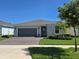 Attractive home featuring a brick driveway, manicured lawn, and a neatly maintained exterior at 6129 Citrus Grove Ct, St Cloud, FL 34771