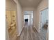 Inviting hallway featuring stylish wood-look flooring, leading to a half bath and the living area at 6129 Citrus Grove Ct, St Cloud, FL 34771