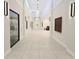 Bright hallway with modern lighting and neutral walls, leading to various community amenities and spaces at 6129 Citrus Grove Ct, St Cloud, FL 34771