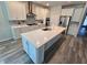 Contemporary kitchen featuring a large island, stainless steel appliances, and ample cabinet space at 6129 Citrus Grove Ct, St Cloud, FL 34771