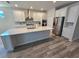Modern kitchen with white cabinets, quartz countertops, stainless steel appliances, and a large island at 6129 Citrus Grove Ct, St Cloud, FL 34771