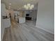 Open-concept kitchen featuring stainless steel appliances and a large island, seamlessly flowing into the living room at 6129 Citrus Grove Ct, St Cloud, FL 34771