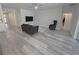Spacious living room featuring wood-look flooring and contemporary furnishings and decor at 6129 Citrus Grove Ct, St Cloud, FL 34771