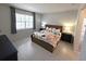 Comfortable main bedroom featuring a large window and a well-coordinated furniture set at 6129 Citrus Grove Ct, St Cloud, FL 34771
