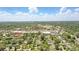 An aerial view of the property in a neighborhood setting on a clear day under a blue sky with fluffy clouds at 619 Byron Rd, Winter Park, FL 32792