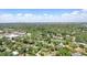 An aerial view of the property in a neighborhood setting on a clear day under a blue sky with fluffy clouds at 619 Byron Rd, Winter Park, FL 32792