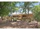 Beautiful backyard featuring a variety of seating options, lush greenery, and shade trees at 619 Byron Rd, Winter Park, FL 32792