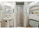 A traditionally-styled bathroom featuring a pedestal sink and a glass door shower stall at 619 Byron Rd, Winter Park, FL 32792