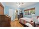 Cozy bedroom with hardwood floors, a desk, and a view to the bathroom at 619 Byron Rd, Winter Park, FL 32792