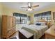 Inviting bedroom with a cozy bed, wood floors, and bright window at 619 Byron Rd, Winter Park, FL 32792