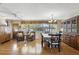 Bright dining area with a wooden table and chairs, complemented by a chandelier and view of the backyard at 619 Byron Rd, Winter Park, FL 32792