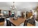 This dining room features hardwood floors and a rustic chandelier, connecting seamlessly to the living area at 619 Byron Rd, Winter Park, FL 32792