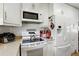 A well-equipped kitchen with white appliances, tile backsplash, and ample storage space at 619 Byron Rd, Winter Park, FL 32792