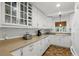 Bright kitchen with white cabinets, a tiled backsplash, and neutral countertops, offering a clean and functional space at 619 Byron Rd, Winter Park, FL 32792