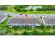 Aerial view of townhomes and landscaping with a street and pond nearby at 652 Benoi Dr, Davenport, FL 33896