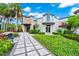 Attractive exterior of arcade building featuring well-maintained landscaping, palm trees, and modern architecture at 652 Benoi Dr, Davenport, FL 33896