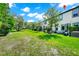 Large backyard with green grass, a swing chair, and a hot tub for outdoor relaxation at 652 Benoi Dr, Davenport, FL 33896