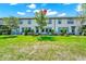 Spacious backyard with green grass, trees, and patio furniture for outdoor enjoyment at 652 Benoi Dr, Davenport, FL 33896