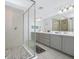Spacious bathroom features a double sink vanity, large mirror, and walk-in glass shower at 652 Benoi Dr, Davenport, FL 33896