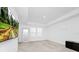 Bright bedroom with a tray ceiling, a large mirror, carpeted flooring, and a view of nature at 652 Benoi Dr, Davenport, FL 33896