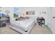 Bright bedroom with a queen bed and toys, filled with natural light at 652 Benoi Dr, Davenport, FL 33896