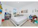 Bright bedroom with a queen bed and toys, filled with natural light at 652 Benoi Dr, Davenport, FL 33896