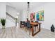 Dining room with modern light fixture, seating for six, and art pieces at 652 Benoi Dr, Davenport, FL 33896
