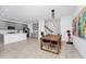 Bright dining area featuring a wood table, modern light fixture, and an open flow into the kitchen at 652 Benoi Dr, Davenport, FL 33896