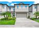 Charming two-story townhouse with attached two-car garage and well-manicured landscaping at 652 Benoi Dr, Davenport, FL 33896