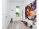 Bright foyer featuring a decorative painting, sleek wood floors, and ample natural light at 652 Benoi Dr, Davenport, FL 33896
