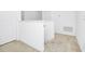 Upstairs hallway featuring neutral carpeting and bright white walls and trim at 652 Benoi Dr, Davenport, FL 33896