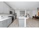 Bright kitchen features gray cabinets, a center island, stainless appliances, and seamless flow to the dining area at 652 Benoi Dr, Davenport, FL 33896
