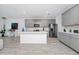 Modern kitchen with gray cabinets, marble backsplash, and a center island with sink at 652 Benoi Dr, Davenport, FL 33896