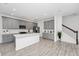 Modern kitchen with gray cabinets, white countertops, stainless steel appliances, and hardwood style floors at 652 Benoi Dr, Davenport, FL 33896