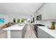Bright, open kitchen with quartz countertops, stainless steel appliances, and views of the living room at 652 Benoi Dr, Davenport, FL 33896