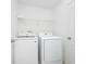 Well-lit laundry room featuring a modern Samsung washer and dryer set and ample storage shelf at 652 Benoi Dr, Davenport, FL 33896