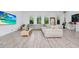 Spacious living room with a large sofa, light colored flooring, and many windows at 652 Benoi Dr, Davenport, FL 33896