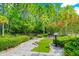 This outdoor miniature golf area features a charming path alongside lush greenery and vibrant flowers at 652 Benoi Dr, Davenport, FL 33896
