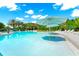 A bright pool offers residents a relaxing retreat with palm trees and lounge chairs at 652 Benoi Dr, Davenport, FL 33896