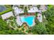 Aerial view of community pool, mini golf, and clubhouse surrounded by lush landscaping at 652 Benoi Dr, Davenport, FL 33896