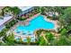 Aerial view of the community pool area with lounge chairs and sun umbrellas at 652 Benoi Dr, Davenport, FL 33896