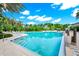 Beautiful community swimming pool with clear blue water and ample lounge seating at 652 Benoi Dr, Davenport, FL 33896