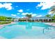A spacious, sparkling pool with umbrellas offers residents a resort-style oasis at 652 Benoi Dr, Davenport, FL 33896