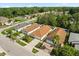 Aerial view of single-Gathering homes with well-maintained lawns, mature trees, and a lush, green backdrop at 6819 Belmar Dr, Orlando, FL 32807