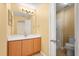 Well-lit bathroom featuring a vanity with storage, a large mirror, and a walk-in shower at 6819 Belmar Dr, Orlando, FL 32807
