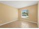 Bedroom features tile floors and a window overlooking the street at 6819 Belmar Dr, Orlando, FL 32807