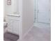 Bathroom featuring a white vanity with granite countertop and modern fixtures at 7352 Oakmoss Loop, Davenport, FL 33837