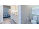 Bathroom view highlighting the vanity with granite countertops and neutral walls at 7352 Oakmoss Loop, Davenport, FL 33837