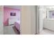 A bright, colorful bedroom with adjoining bathroom showcasing a seamless design at 7352 Oakmoss Loop, Davenport, FL 33837